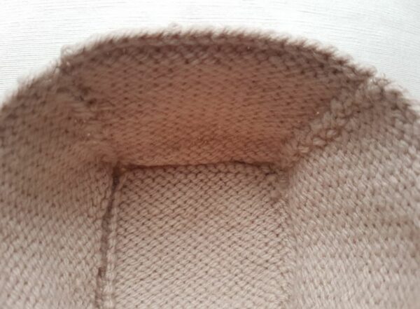 Close-up of brown fur lining on a fabric surface.