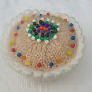 Decorative item with colorful beads on a textured surface