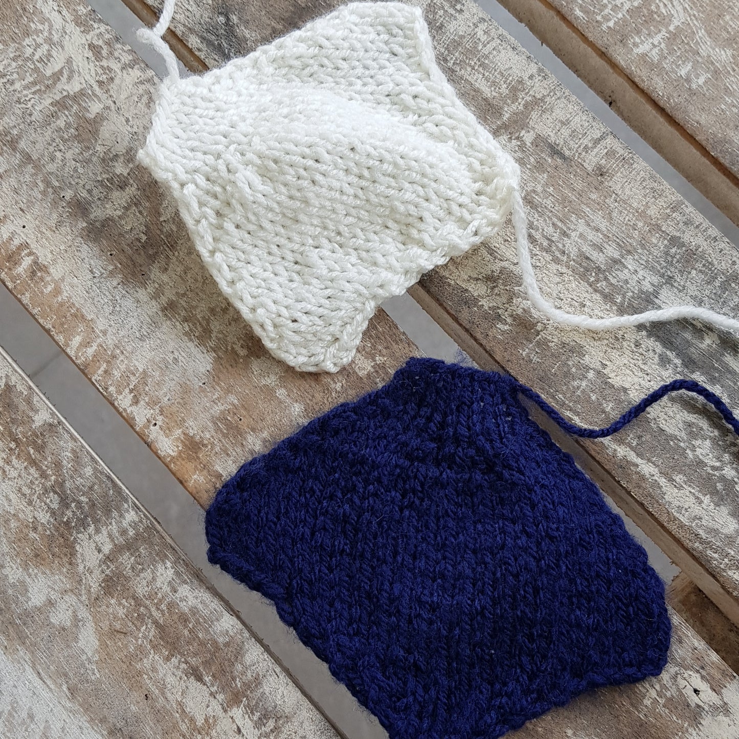 Individual knitted body parts for a manta ray toy, laid out before assembly.