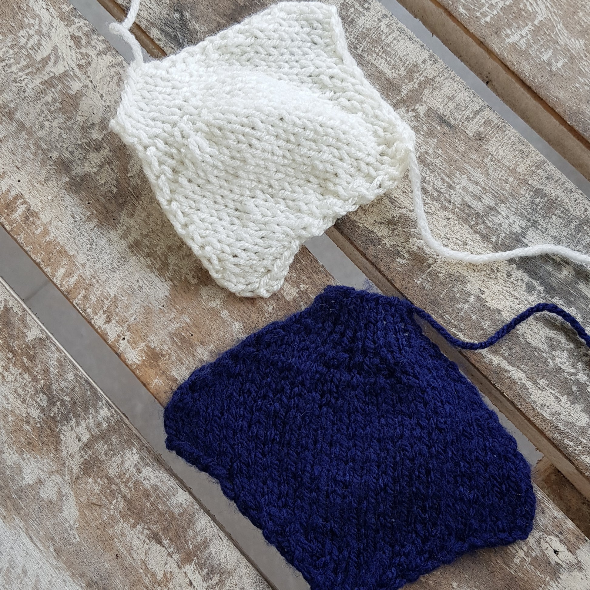 Individual knitted body parts for a manta ray toy, laid out before assembly.