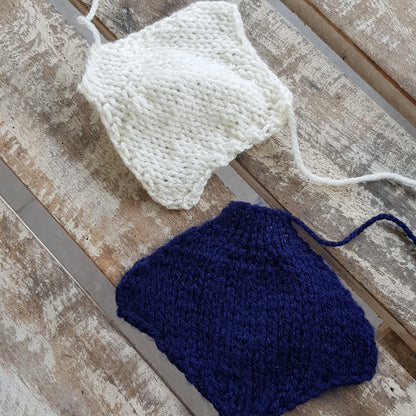 Individual knitted body parts for a manta ray toy, laid out before assembly.