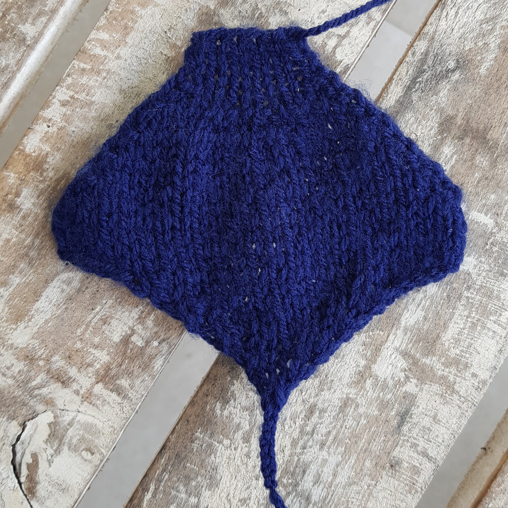 Dark blue hand-knitted manta ray body piece, made using the Fitting in Knitting Manta Ray knitting pattern.