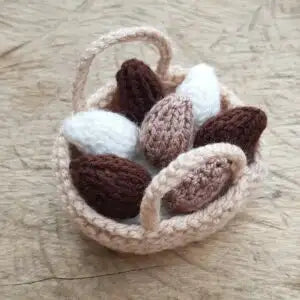 Little Basket of Knitted little eggs fitting in knitting
