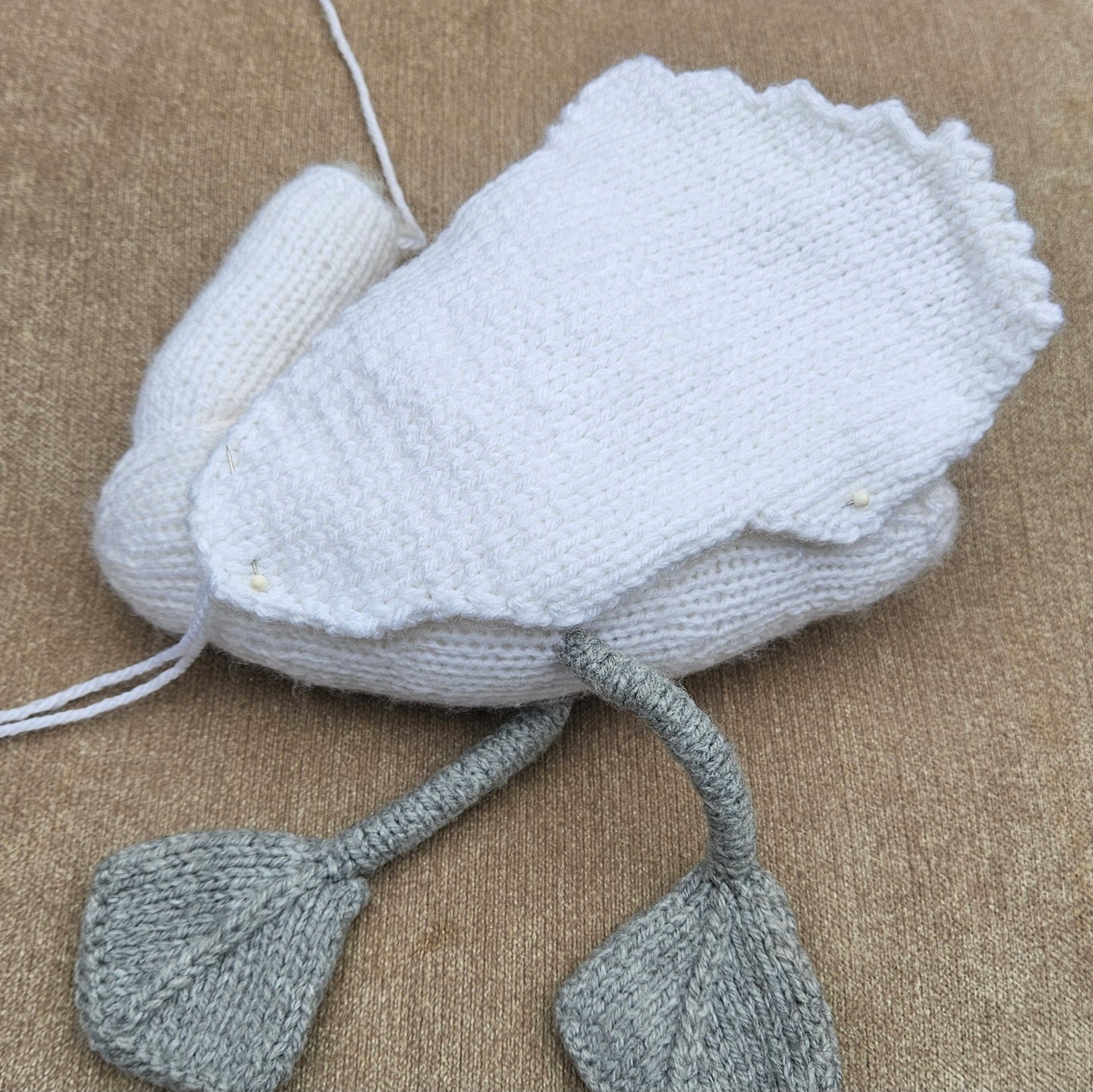 Homemde Knitted swan toy on a beige background