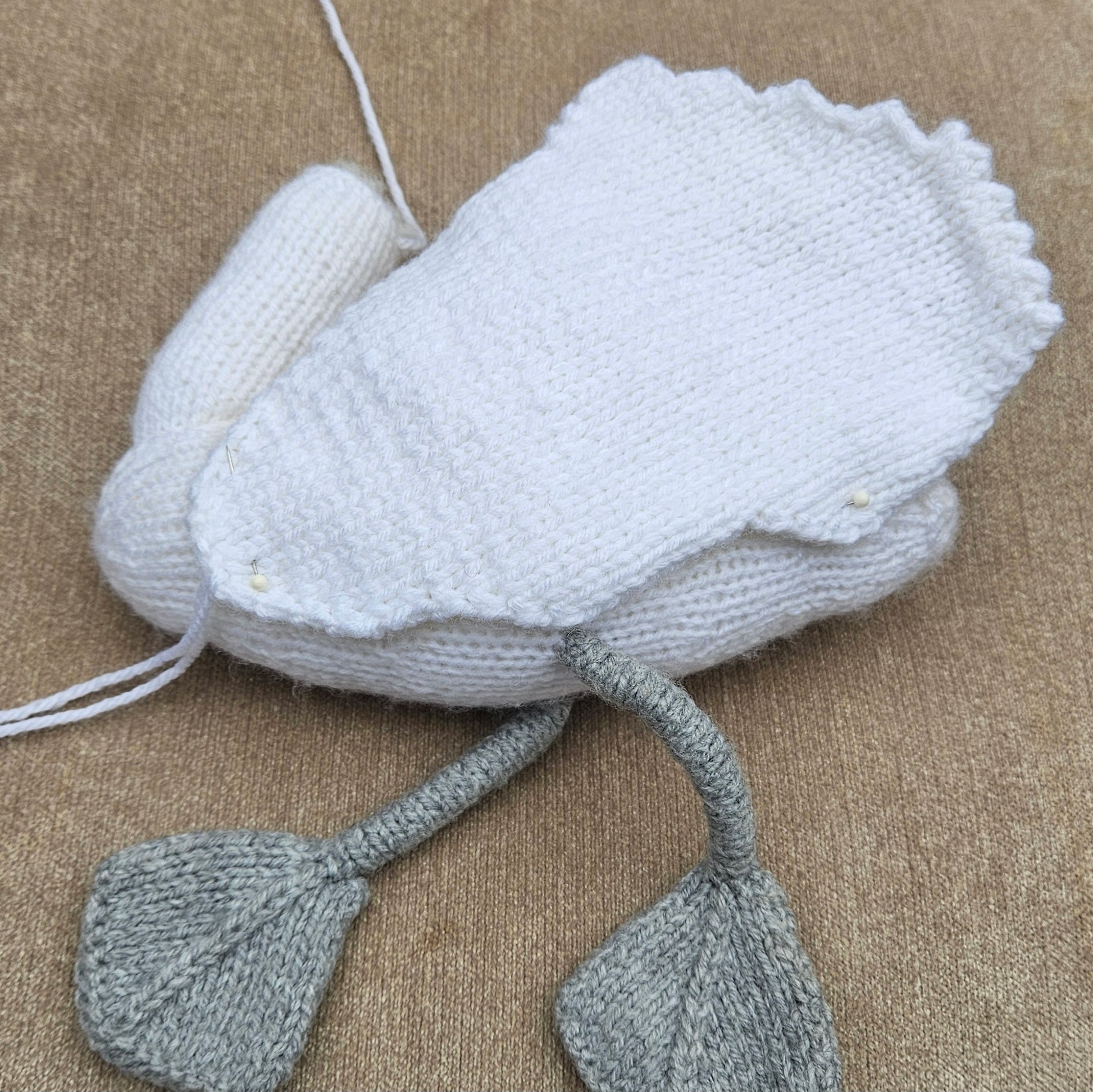 Homemde Knitted swan toy on a beige background